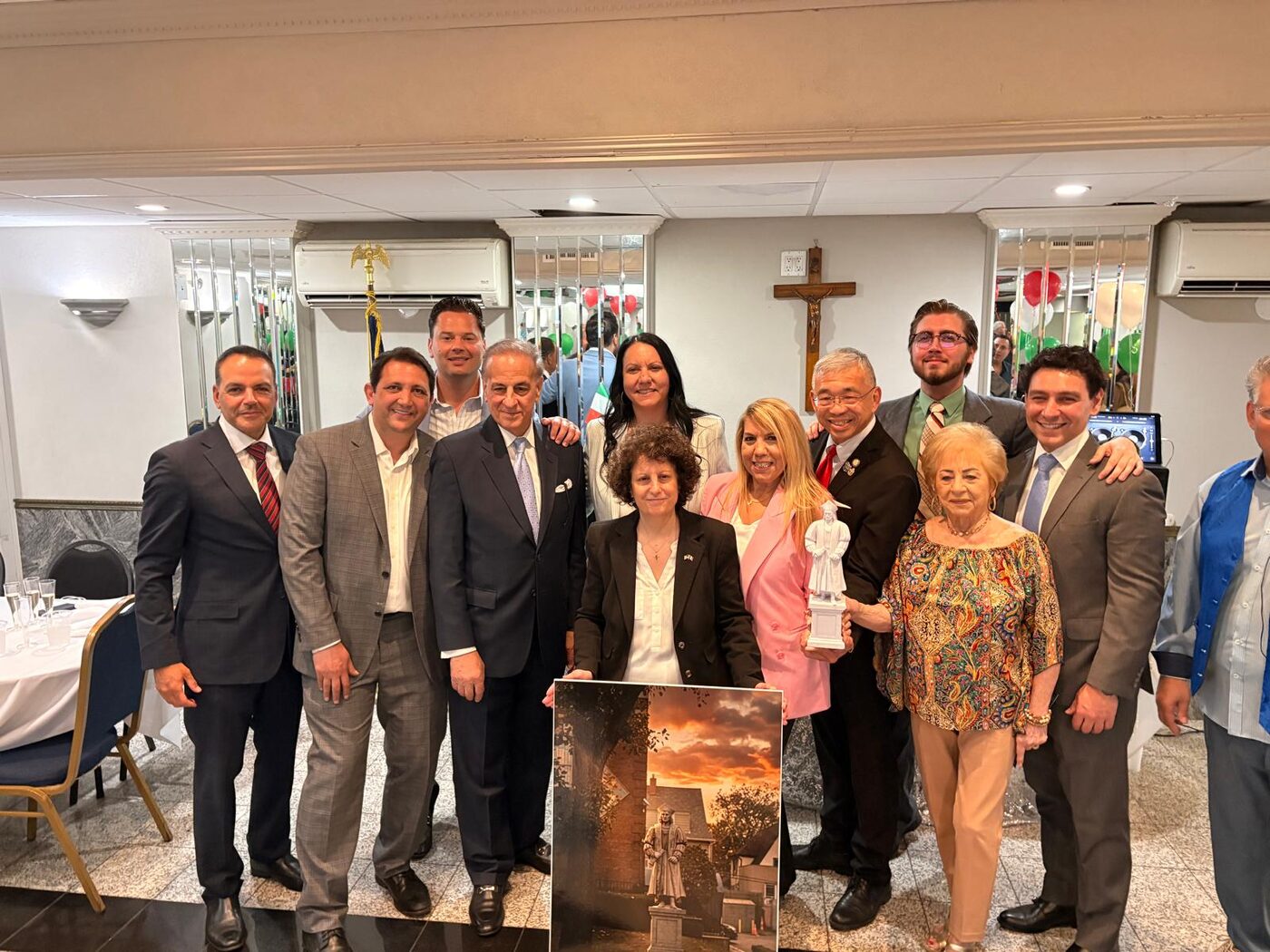 Preserving Italian-American Heritage Coalition committee members gathered together, holding a model of the Columbus statue and a rendering of the finished monument